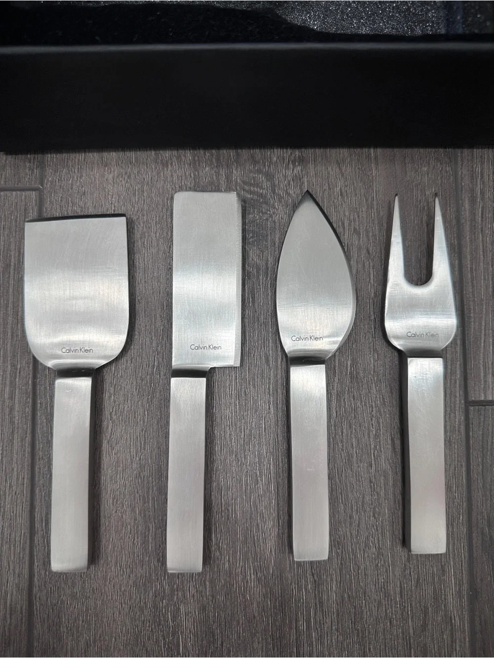 Calvin Klein stainless steel cheese serving set by Calvin Klein Home collection.